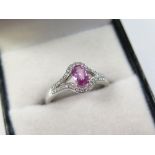 18ct White Gold Ring with central pink Sapphire surrounded by Diamonds size N weight 3.9 grams