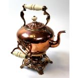 A Victorian Copper Kettle on stand with burner, ceramic handles and ornate scrolled decoration.