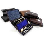 Twelve compass sets, all in leather cases