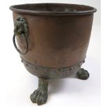 Large copper and brass log / coal bucket raised on three feet, with lion handles, circa 19th