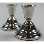 Pair of small matching silver candlesticks, Hallmarked 'Birmingham 1968', height 8.2cm approx.,