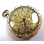 18ct gold ladies fob watch, black roman numerals on a gilt decorated dial. approx 35mm diameter