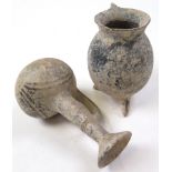 Two Ancient pottery jugs, both with handles, one raised on three legs, height 13.5cm and smaller