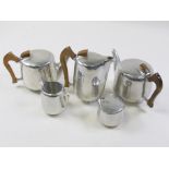Four piece tea set by Picquot Ware, together with one extra teapot, Height 14.5cm and smaller