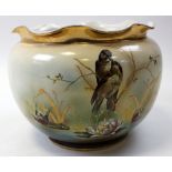 Large ceramic jardiniere depicting a pair of reed warblers sitting on a branch above lily pads, with