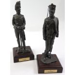 Pair of modern metal statues of soldiers, each on a wooden plinth with plaque, 'CPL Scots Greys 1815