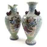 Pair of large Oriental vases, ornately decorated, one with damage to top (piece is still present),