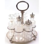 Cruet set comprising of six cut glass bottles, three with hallmarked silver tops, the remainder with