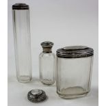 Three ornate silver topped glass vanity bottles, Hallmarked 'C.J.F., London 1893', plus one other