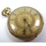 Ladies 18ct gold Hallmarked pocket watch the gilt dial with black roman numerals, foilate design