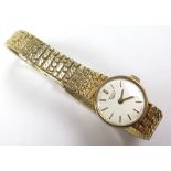 Ladies 9ct gold Longines wristwatch, the circular silvered dial with gilt baton markers on a 9ct