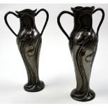 Pair of Liberty style pewter vases, one still retaining partial glass liner, height 29.2cm approx.