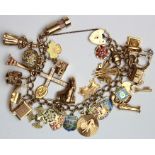 9ct gold charm bracelet with a good quantity of charms attached. Total weigh approx 67g