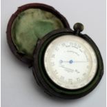 A travelling pocket aneroid barometer by Lawrence and Mayo, London. in its original case but case