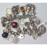 Silver charm bracelet with a good selection of charms (three charms need attaching). Total weight