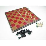 Complete set of thirty-two lead chess pieces with Spalding chess board