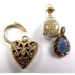 Three Yellow Metal Charms including a jar of gold dust weight 5.6 grams