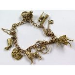 9ct gold charm bracelet with eight charms attached , total weight 22.4g