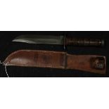 An unused USMC KA-BAR Combat knife. Bowie blade 7". Ricasso marked 'USMC'. Leather grip. In its