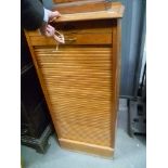 Edwardian pale oak tambour front filing cabinet with nine slide drawers, width 19'