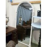 19th Century tall arched mirror, the white painted moulded frame with half fluted and stiff leaf