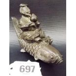 Oriental bronze finial modelled as a gentleman on the back of a carp fish, width 4'