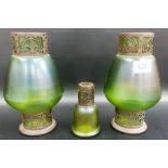 Pair of Loetz style green iridescent glass vases, the base and rim encased with metal scroll mounts,