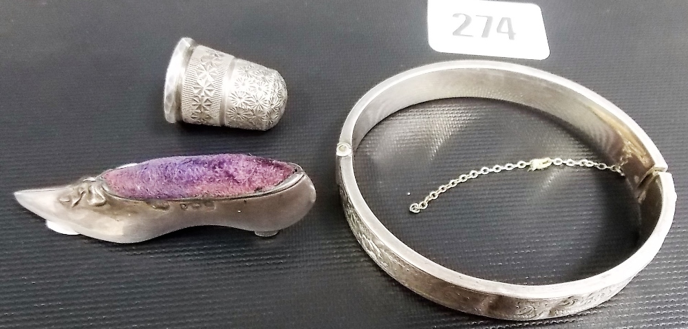 A Charles Horner silver thimble; together with an Edwardian silver slipper pin cushion and a