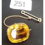 Yellow metal large cushion shaped citrine brooch with safety chain and pin, width of stone 25mm