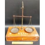 Set of brass Chemists balance scales upon walnut rectangular base with single drawer