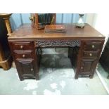 Good late 19th/early 20th Century Chinese hardwood twin pedestal desk, with an arrangement of four