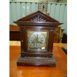 German Oak two train mantle clock with architectural case and 5.5' brass square dial, with