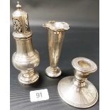 Silver pedestal sugar caster, Birmingham 1937; together with a silver weighted squat candlestick and