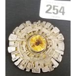 Mid-Century silver abstract circular brooch the centre inset with a circular stepped cut citrine,