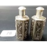 Pair of 20th Century Chinese white metal small hexagonal pepper shakers, each panel foliate