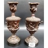 Pair of 19th Century bronze candlesticks, of pedestal urn form, the body decorated in relief with