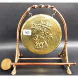 Victorian aesthetic movement brass and copper dinner gong, the gong hammered and embossed with Iris,