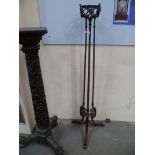 Arts and Crafts wrought iron oil standard lamp stand raised on three supports, height 52'