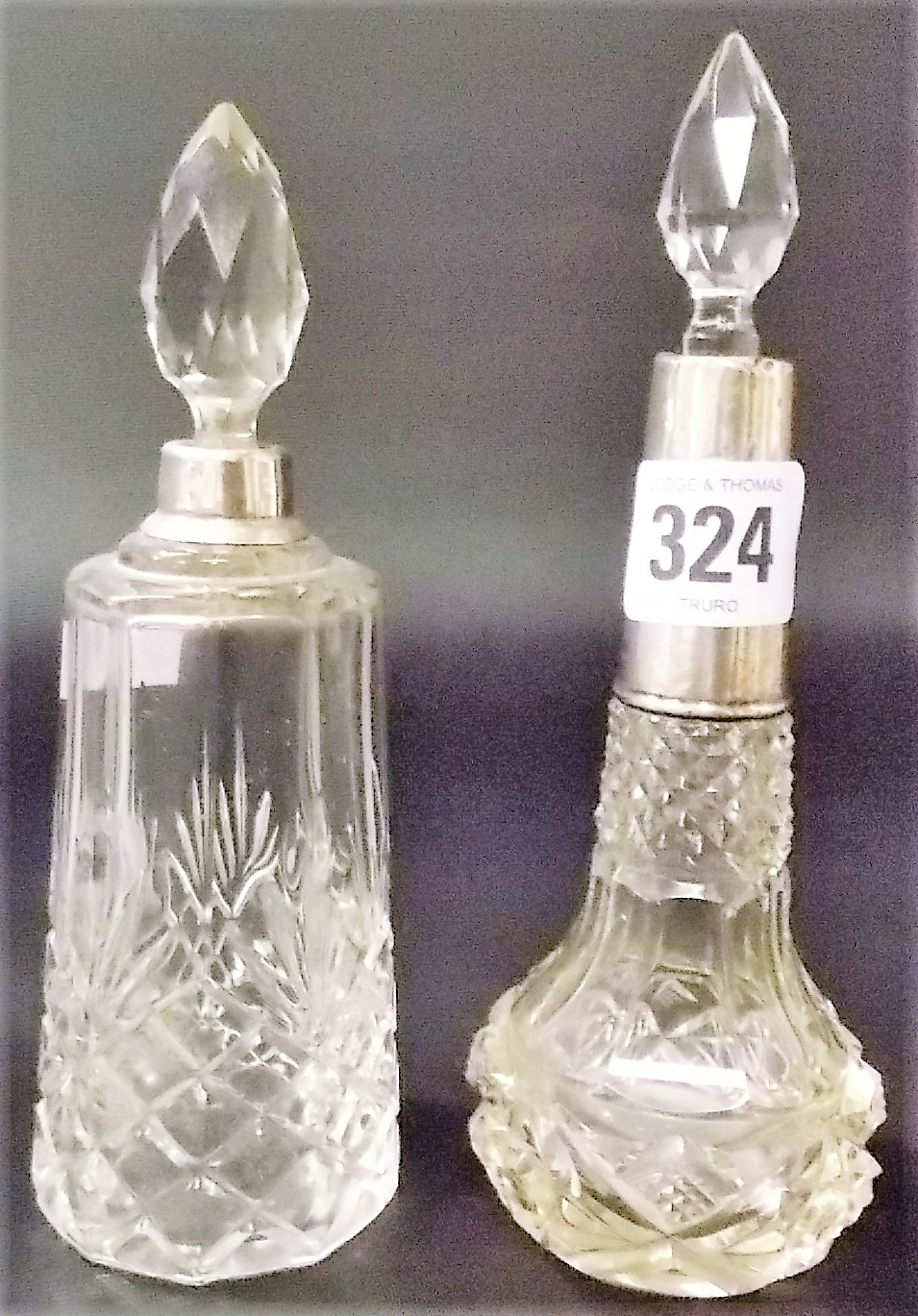 Two cut glass silver rim scent bottles and stoppers, one London 1921 (2)