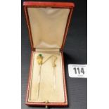 Fine Victorian double stick pin modelled as a hand holding an emerald gem and wearing a turquoise