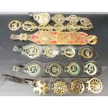 Collection of Victorian and later horse brasses upon straps