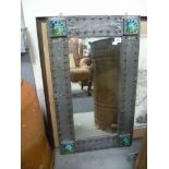 Arts and Crafts rectangular wall mirror, the pewter frame with studwork, the corners with