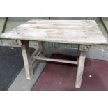 Rustic pine rectangular garden table upon rectangular supports united by an H-stretcher, width 28.