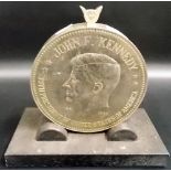 John F. Kennedy 1961 - 1963 chrome plated medallion table lighter upon cast iron stand, one side