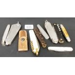 A collection of ten various folding pocket knives