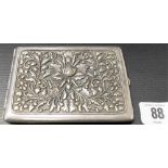 Eastern white metal rectangular cigarette case, the repousse decorated lid with a foliate lotus