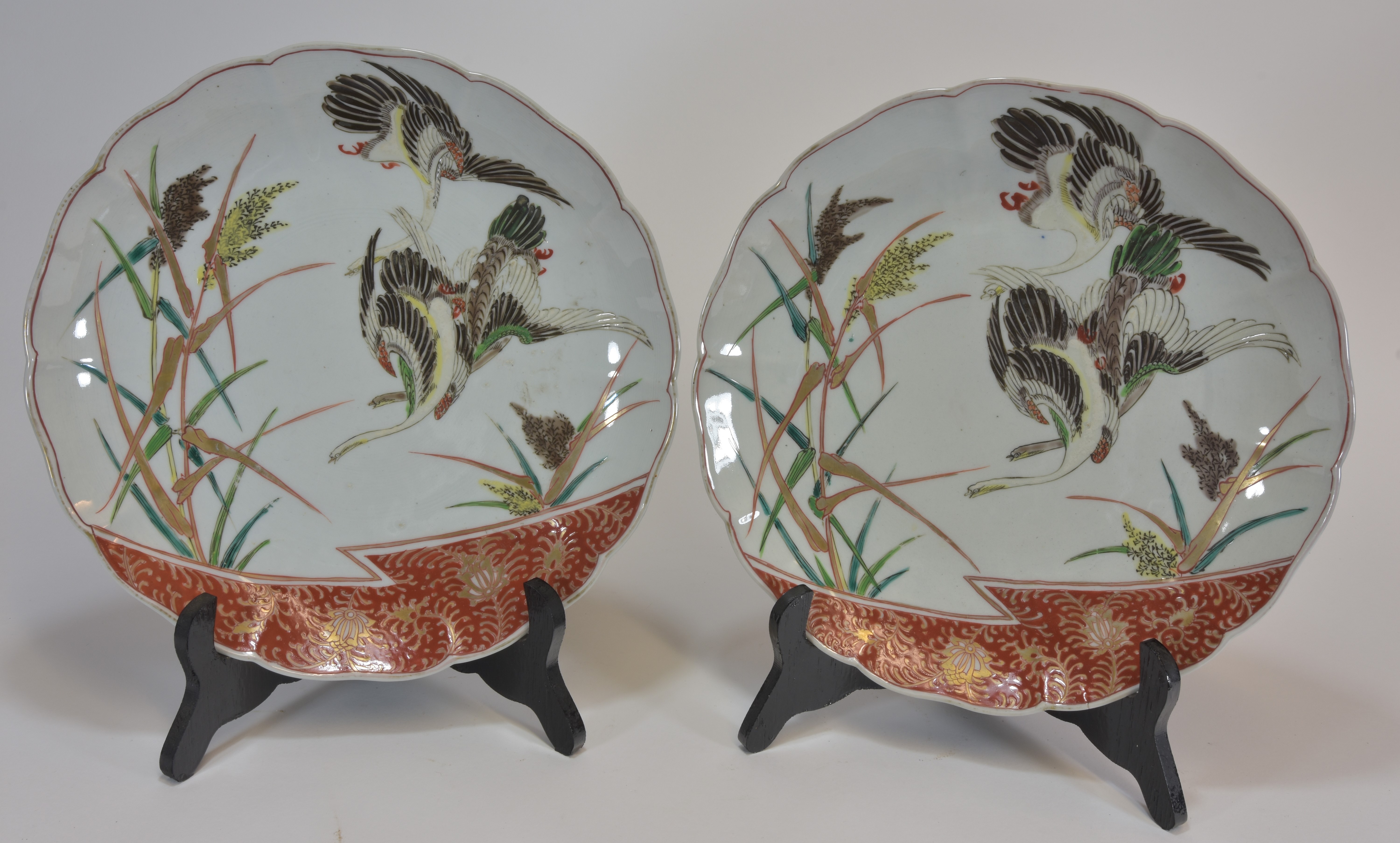 A pair o f Japanese Imari dishes decorated with flying cranes bearing old label of Liberty 28cm