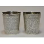 A pair of Indian solid silver beakers with gold gi