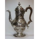 A solid silver chinoiserie coffee pot with wooden