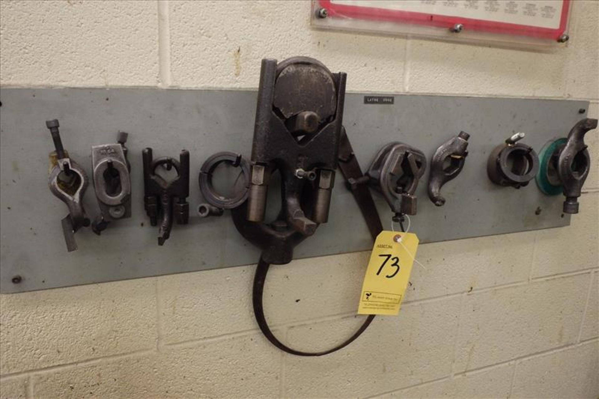 Quantity of Assorted Clamps on Wall